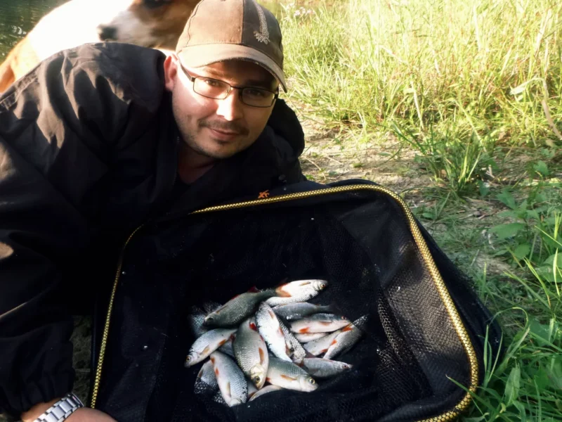 Christoph mit gefangen Rotfedern und Rotaugen im Kescher mit geschroteten Leinsamen