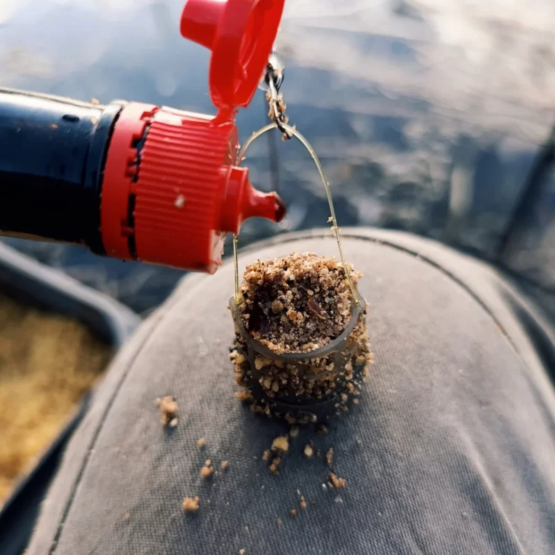 Maggi wird über einen kleinen Futterkorb geträufelt